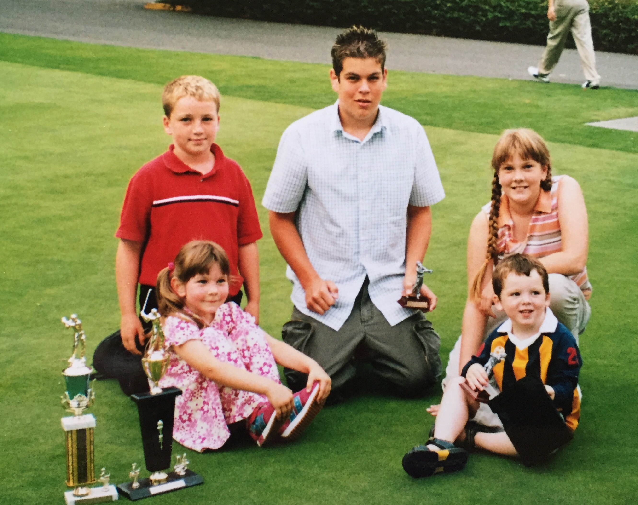 Cole and Maddie as kids on a golf course